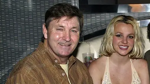 Getty Images Jamie Spears, Britney's father, sits next to her in 2018