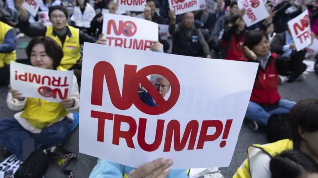 Close-up of a sign that reads "No Trump!" in red bold letters