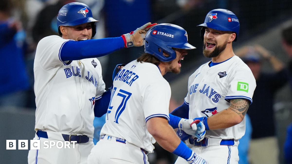 Addison Barger (centre) is congratulated by Toronto Blue Jays team-mates George Springer and Nathan Lukes after hitting his grand slam