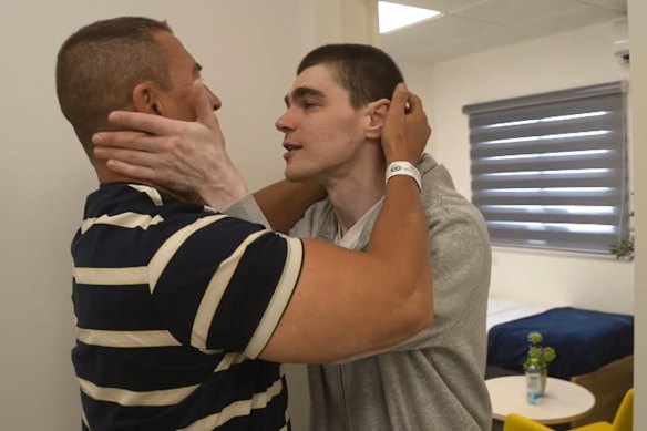 Maksym Harkin, right, meets with his family after being released from Hamas captivity.