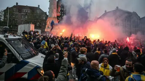 Getty Images Fans of Maccabi Tel Aviv stage a pro-Israel demonstration at the Dam Square, lighting up flares