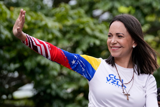 FILE - Opposition leader Maria Corina Machado waves from atop a truck during the closing election campaign rally for presidential candidate Edmundo Gonzalez in Caracas, Venezuela, Thursday, July 25, 2024. (AP Photo/Matias Delacroix, File)