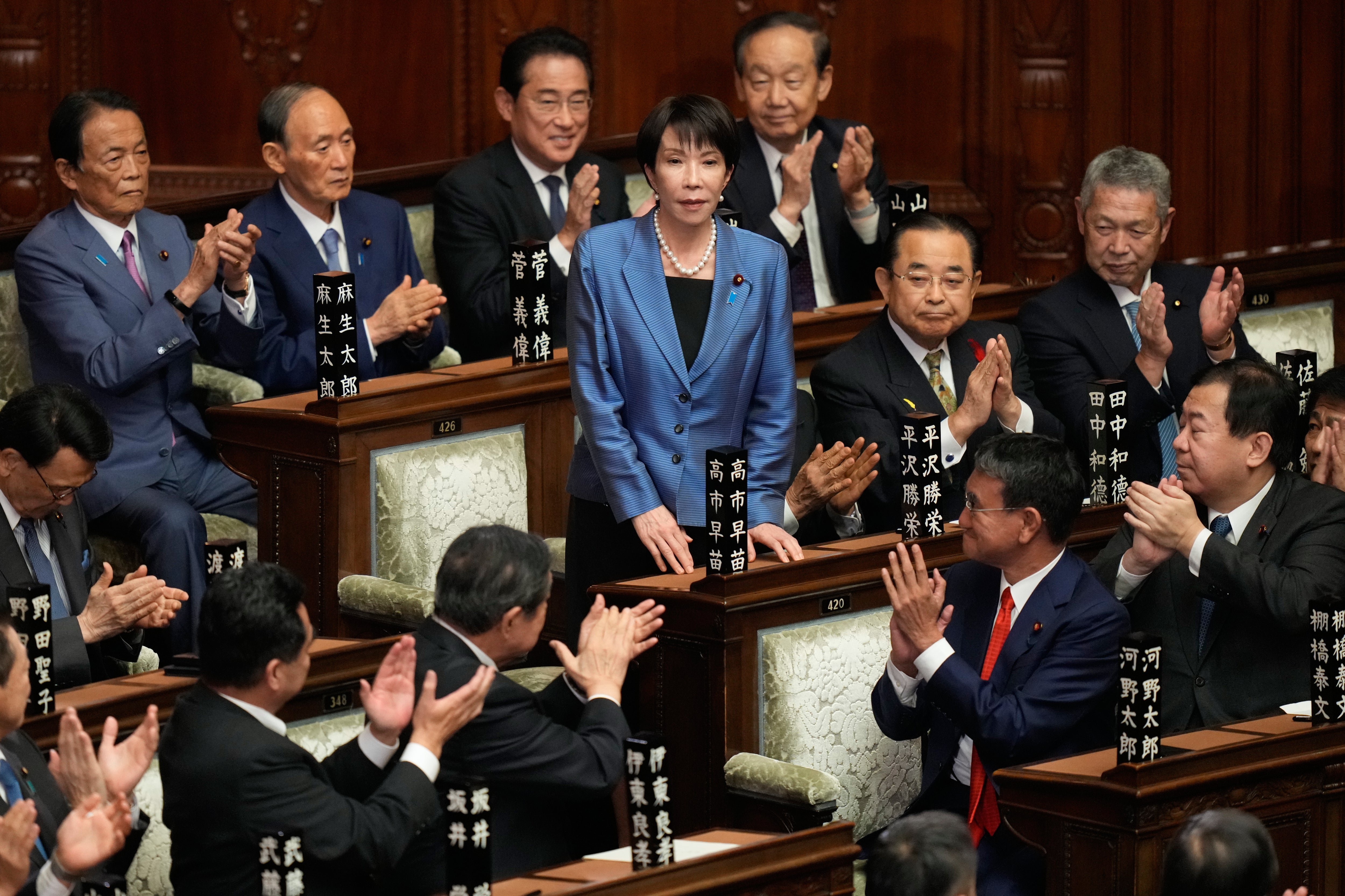 Lawmakers applaud as Sanae Takaichi, center, is elected as Japan's new prime minister during the extraordinary session of the lower house, in Tokyo, Japan