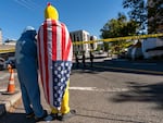 Protesters wave to passersby as they wait outside of the U.S. Immigration and Customs Enforcement building in South Portland, where U.S. Department of Homeland Security Secretary Kristi Noem is visiting, Oct. 7, 2025.