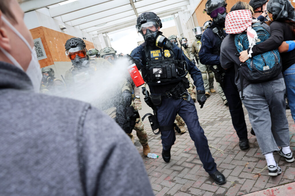 Federal agents confront protesters outside a Immigration and Customs Enforcement facility in Portland, Oregon, on Oct. 4.