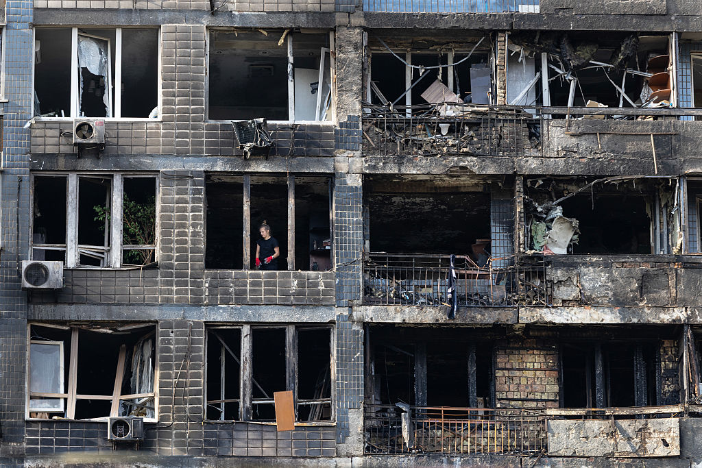 Workers clear debris following a drone attack on a residential building that injured at least nine people on 10 October 2025 in Kyiv, Ukraine (Paula Bronstein /Getty Images)
