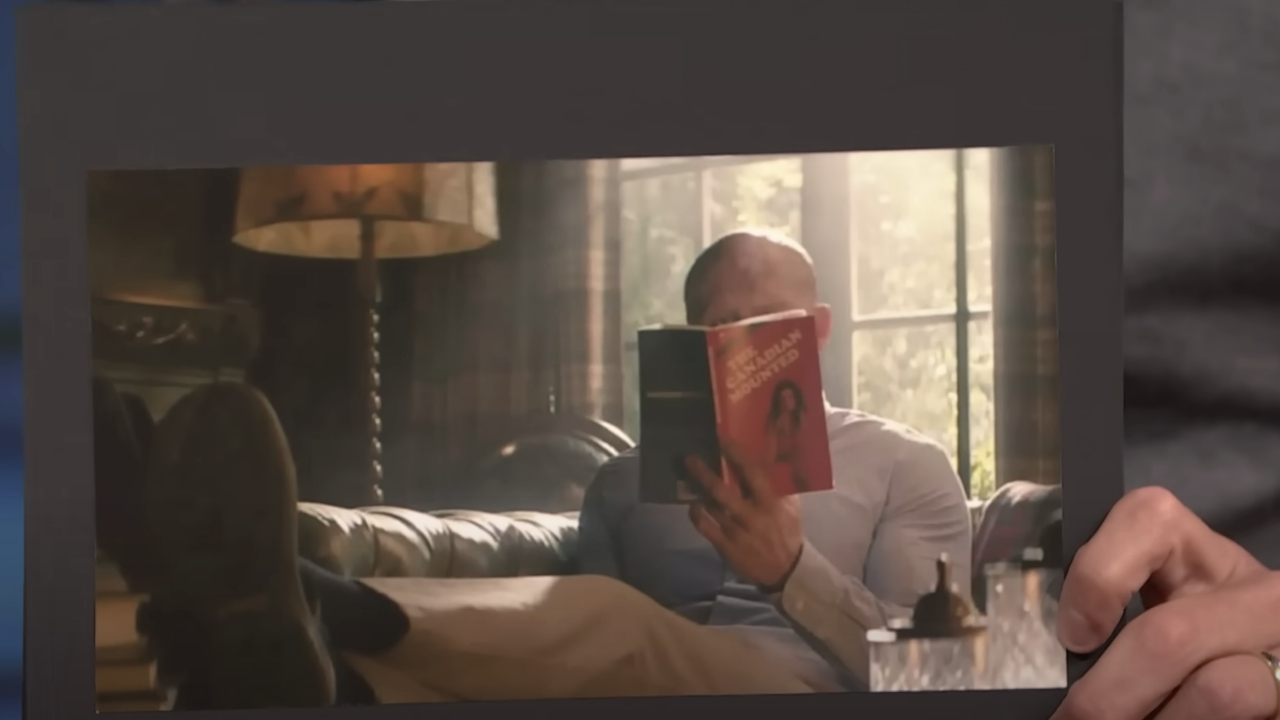 Seth Meyers holds up a photo from the Deadpool 2 extended cut.