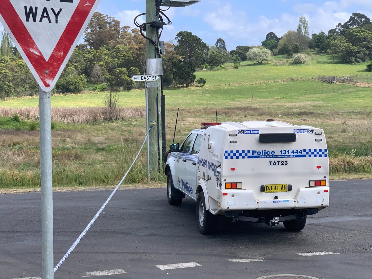 A NSW Police vehicle parked next to police tape