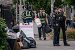 Workers with Rapid Response Bio-Clean, a refuse removal company, haul out items from in front of the U.S. Immigration and Customs Enforcement building on Wednesday, Oct. 8, 2025 in Portland, Ore. This is the ninth time the City of Portland has cleaned up protester's supplies and belongings in front of the building eight since June.