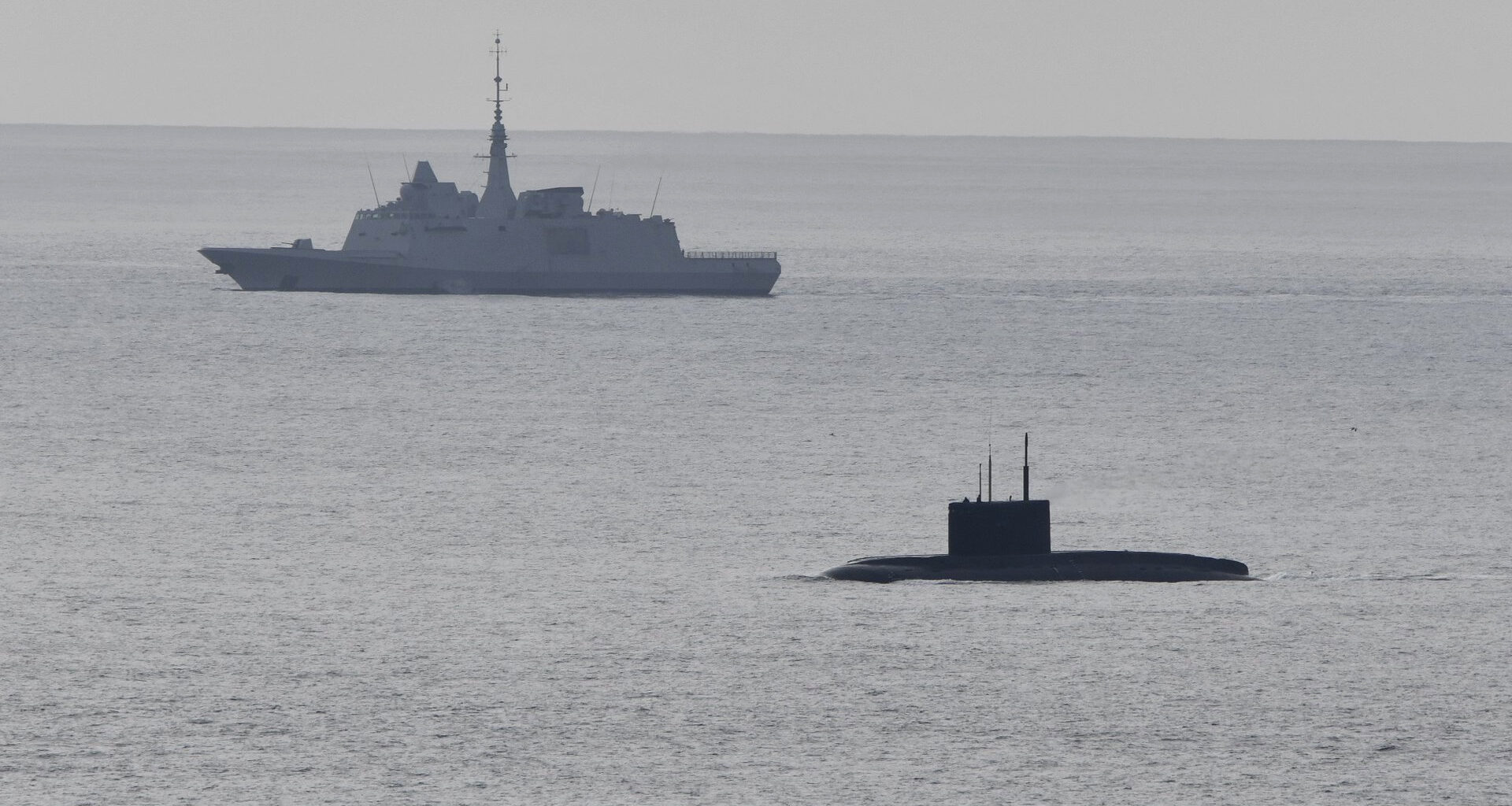 A Russian submarine previously operating in the Mediterranean has surfaced off France after reports it suffered a fuel leak near Gibraltar.