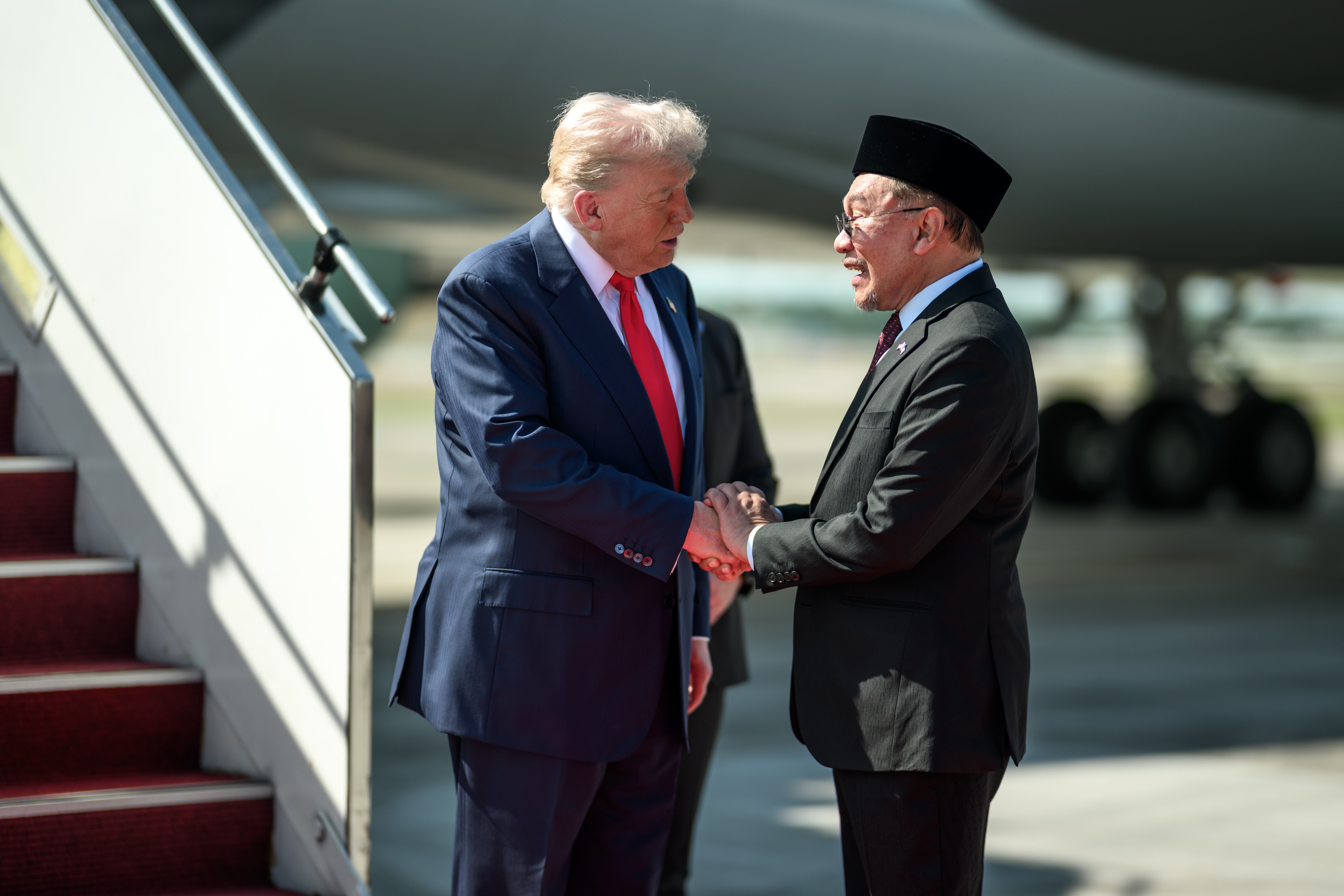 President Donald Trump is greeted by Malaysian Prime Minister Anwar Ibrahim after his arrival at Kuala Lumpur International Airport in Kuala Lumpur, Malaysia, Sunday, October 25, 2025. (Official White House Photo by Daniel Torok)