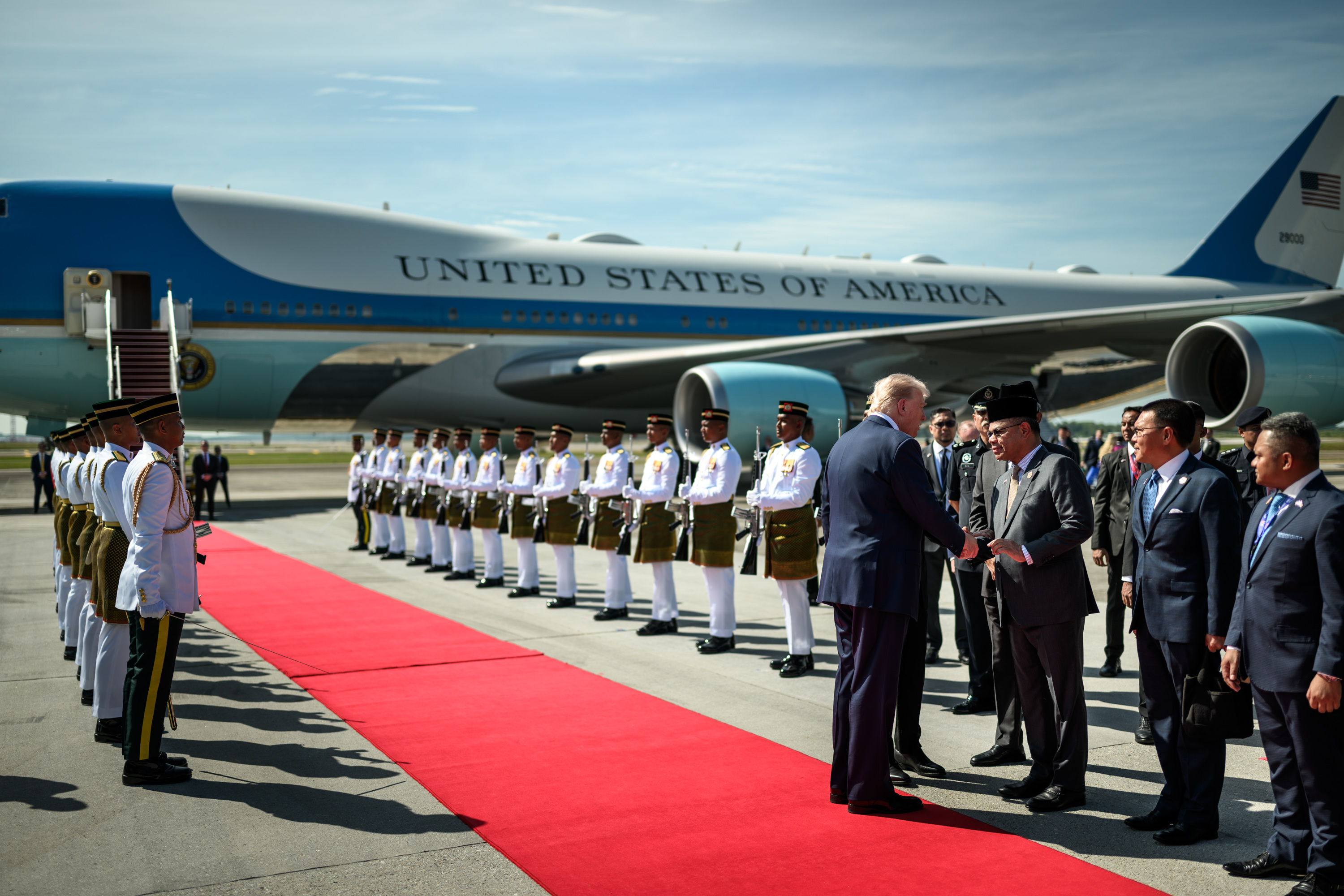 President Donald Trump is greeted by Malaysian Prime Minister Anwar Ibrahim and others during an arrival ceremony at Kuala Lumpur International Airport in Kuala Lumpur, Malaysia, Sunday, October 25, 2025. (Official White House Photo by Daniel Torok)