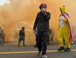 Protesters recover after tear gas is deployed at the U.S. Immigration and Customs Enforcement facility, Portland, Ore., Oct. 4, 2025.