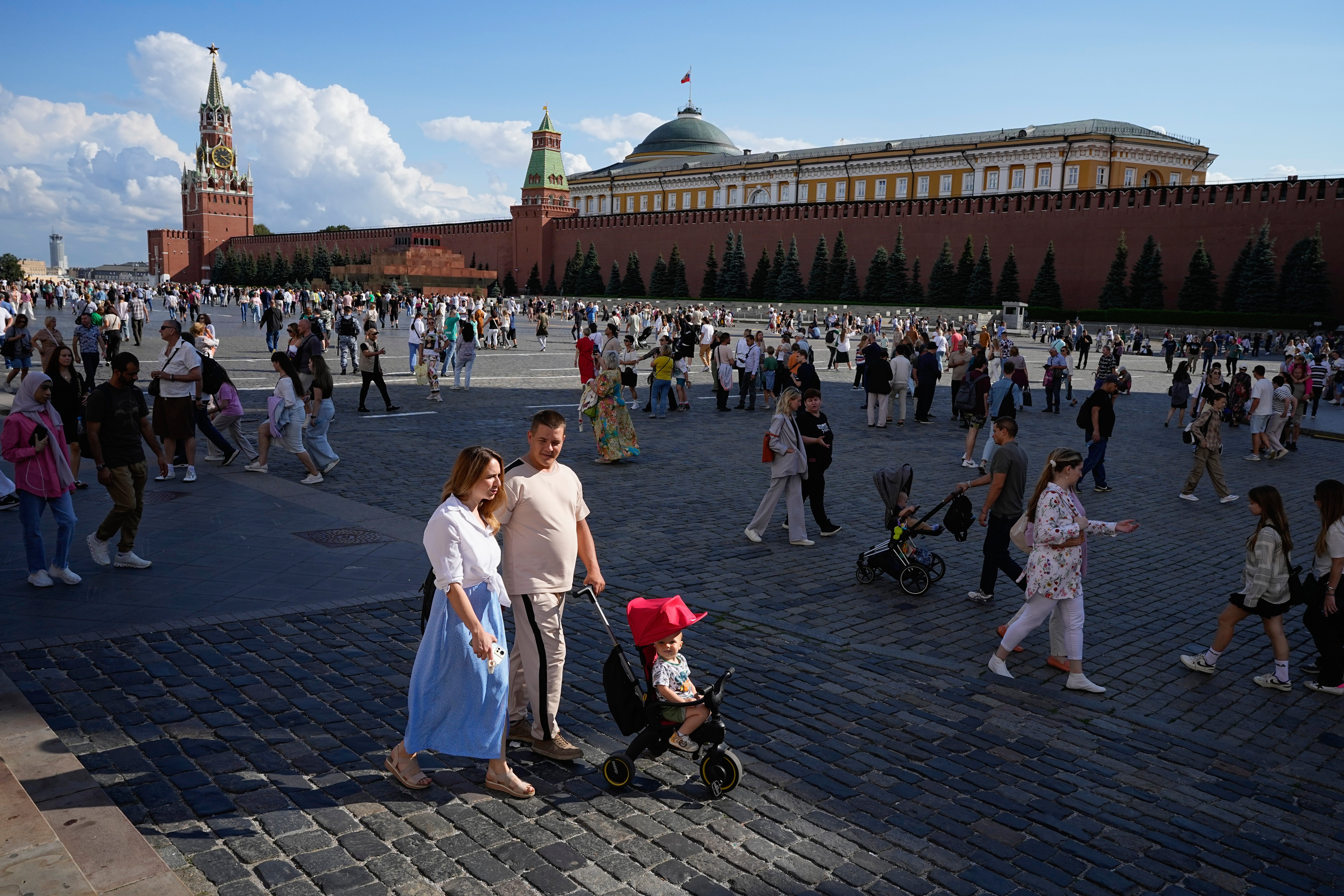 A family walks through Red Square in Moscow, Russia, Sunday, Aug. 4, 2024. (AP Photo/Alexander Zemlianichenko, File)