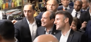 Sisi and Macron in a crowd of security dudes