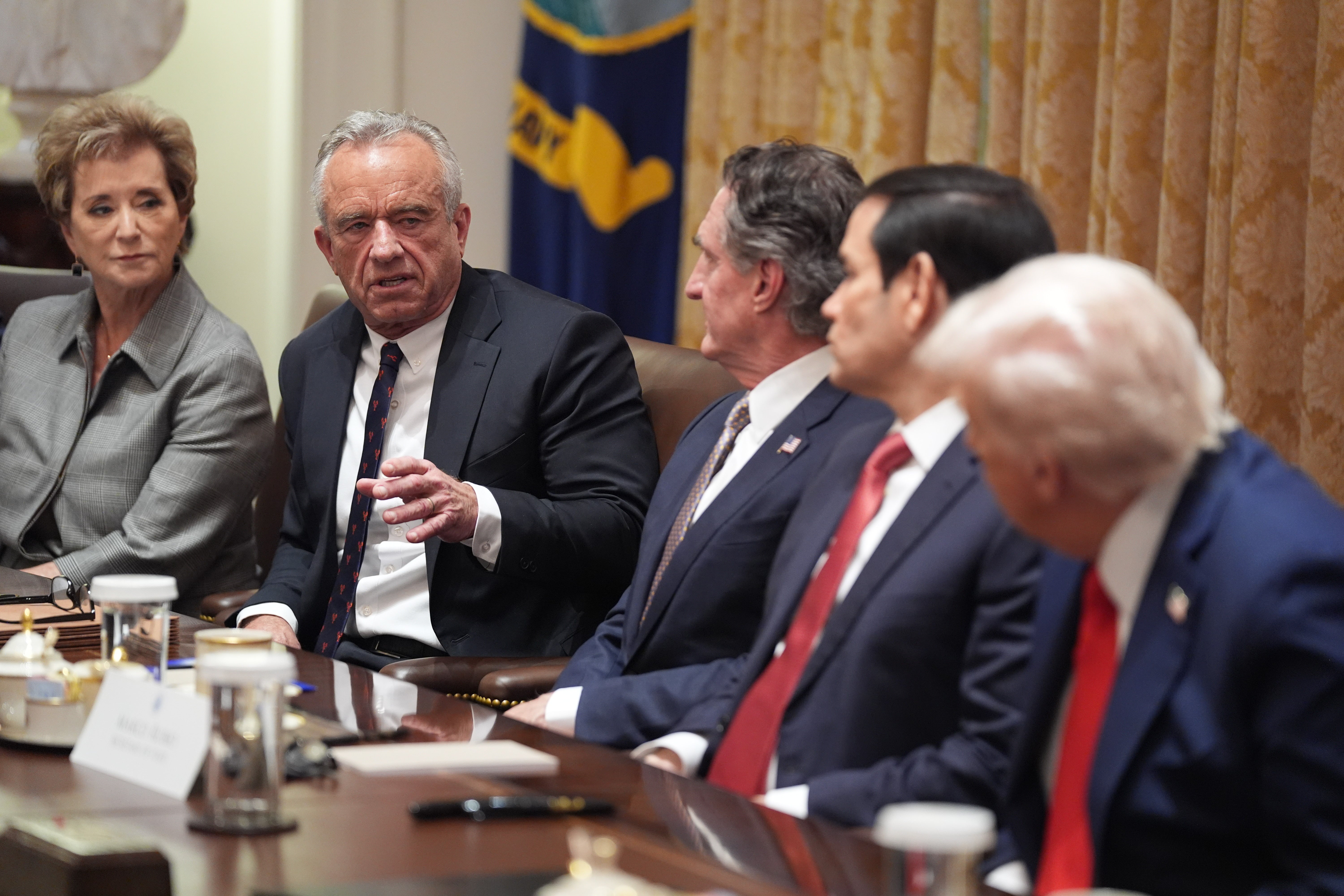 Human Services Secretary Robert F. Kennedy, Jr., speaks as President Donald Trump holds a cabinet meeting at the White House, Thursday, Oct. 9, 2025, in Washington. From left, Education Secretary Linda McMahon, Kennedy, Interior Secretary Doug Burgum, Secretary of State Marco Rubio and President Donald Trump, look on. (AP Photo/Evan Vucci)