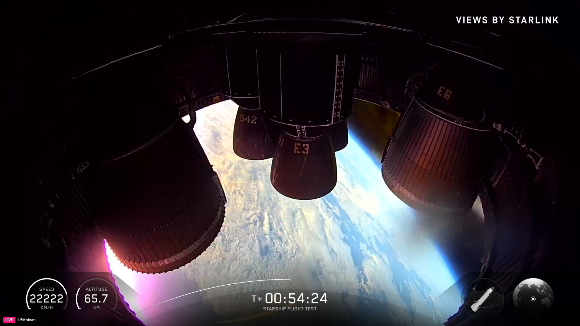 The engines of a SpaceX Starship surrounded by red hot plasma during reentry on Flight 11 with the Earth visible below.