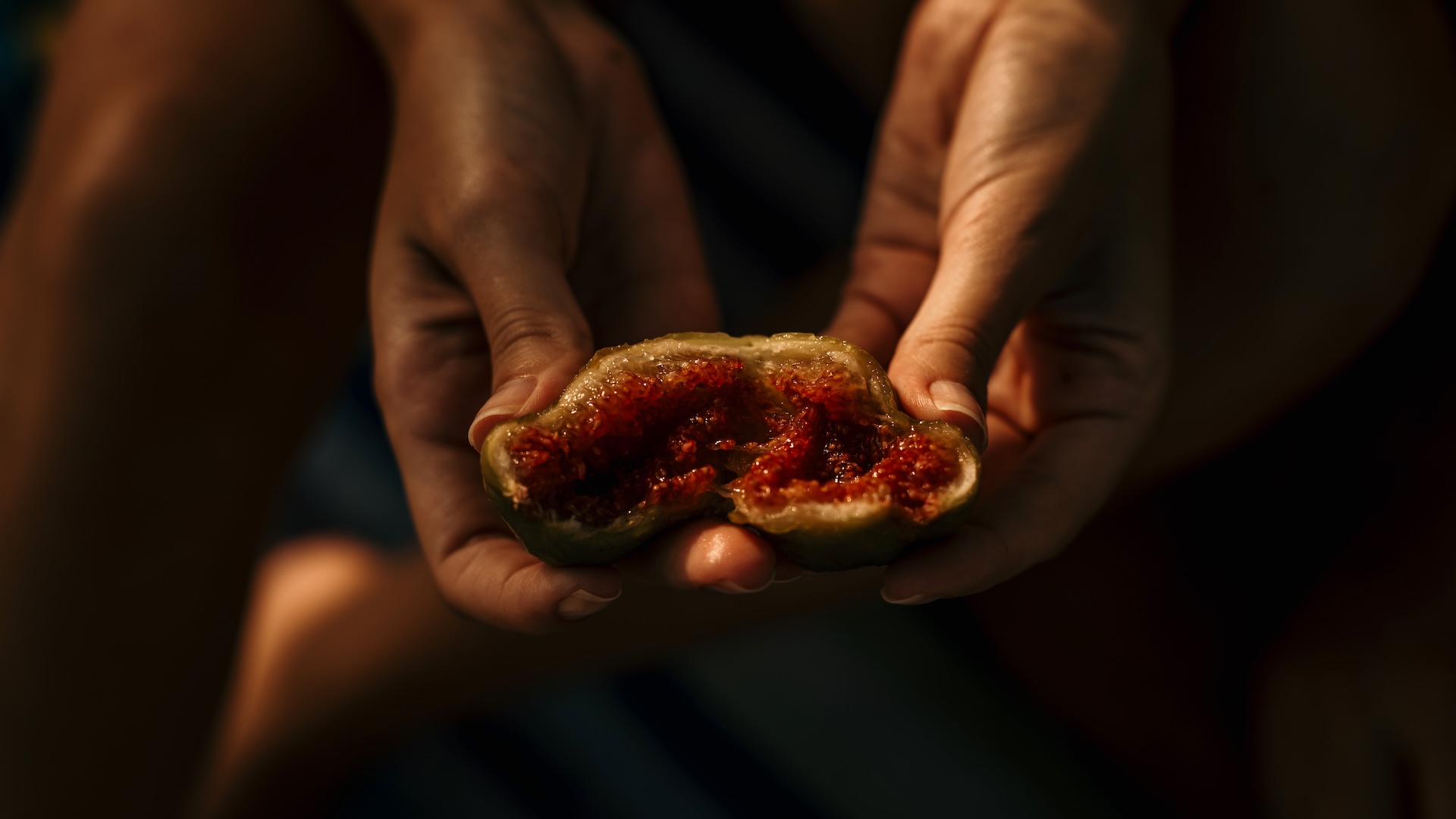 A photograph of a person holding an open fig