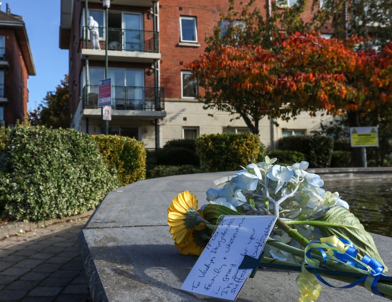 Flowers with a message and ribbons in the Ukrainian flag colours on a fountain beside the apartment in Donaghmede, Dublin, where the Ukrainian teenager died in an incident on Wednesday. Photograph: Colin Keegan/Collins Dublin