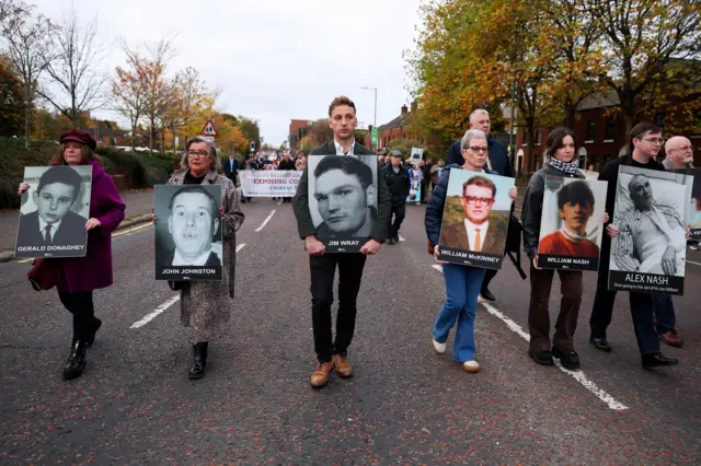 Family members hold pictures of victims of the 1972 'Bloody Sunday'