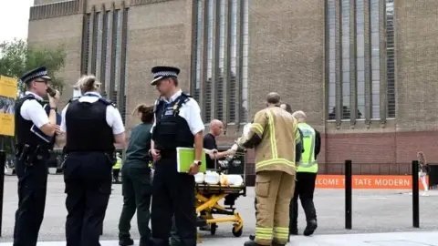 AFP Police officers outside Tate Modern following boy's fall with stretcher behind