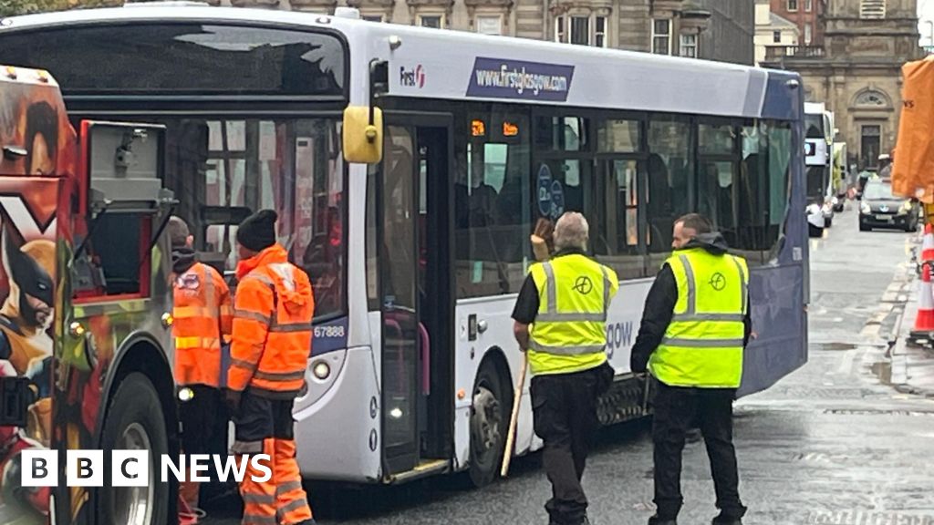 Driver taken to hospital after bus crashes into Glasgow building