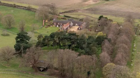 Shutterstock An aerial view of Wood Farm on the Sandringham estate. It is a large farmhouse hidden behind rows of trees and situated among roling fields.