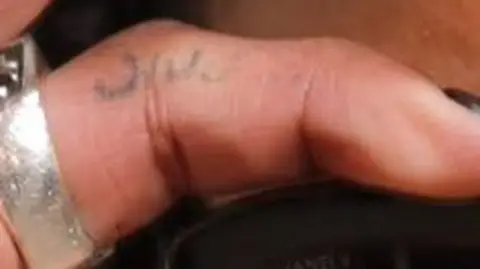Getty Images A faint tattoo is seen on a close-up picture of D4vd's finger