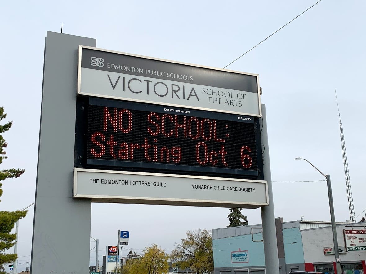 An electronic sign outside of Victoria School for the Arts in Edmonton says, "No School: Starting Oct. 6."