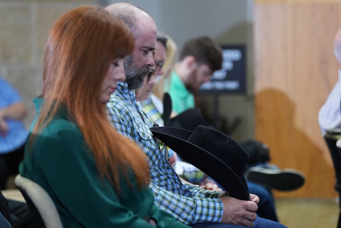 Angie and Shawn Ayers pause during a moment of silence at Monday's news conference.
