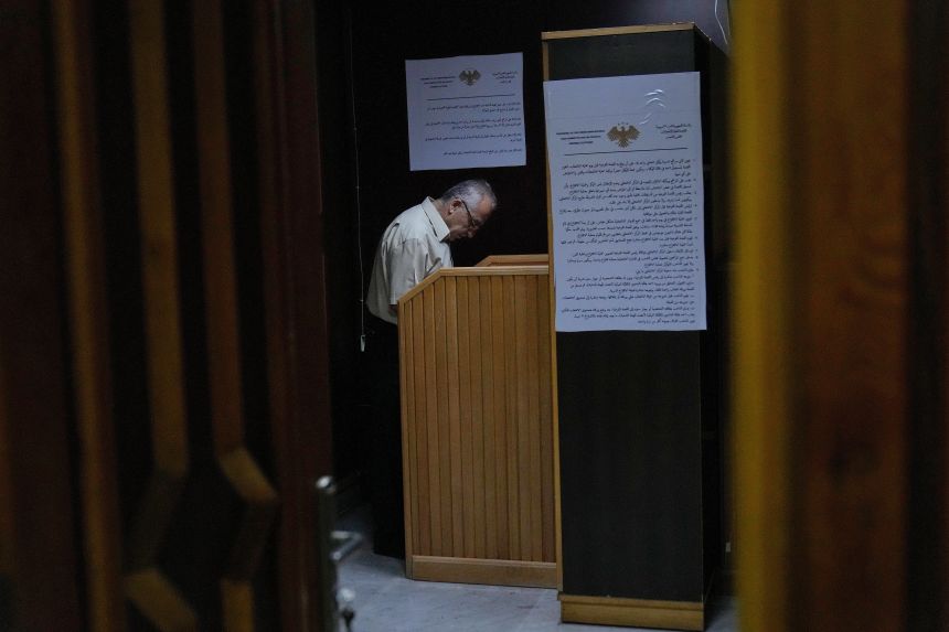 A Syrian electoral college member fills his ballot at the secret room during the parliamentary elections at a ballot station, in the coastal city of Latakia, Syria on October 5, 2025.