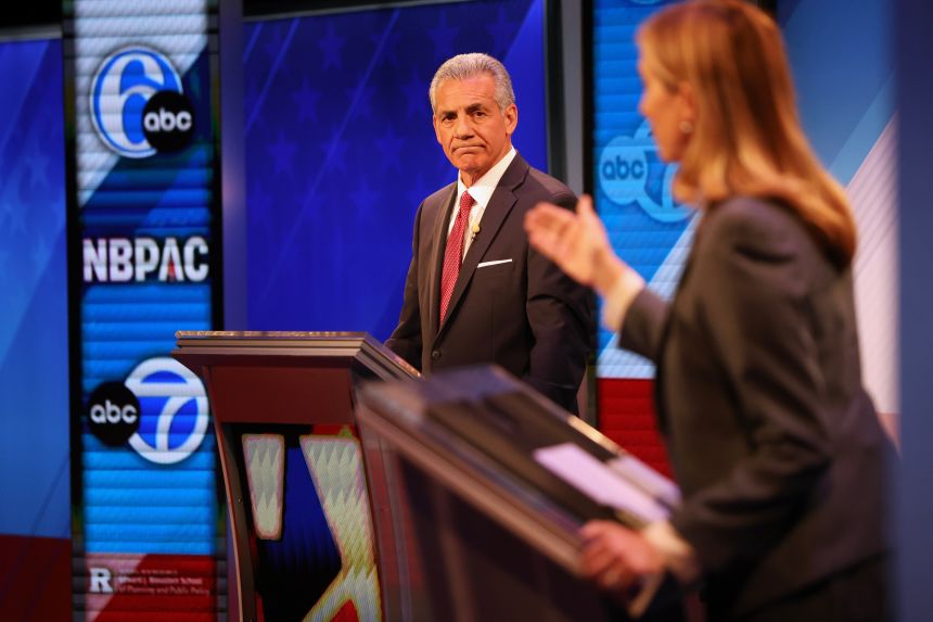 Republican Jack Ciattarelli, left, looks on while Democrat Mikie Sherrill speaks during the final debate in the New Jersey governor's race, Wednesday, Oct. 8, 2025, in New Brunswick, New Jersey.