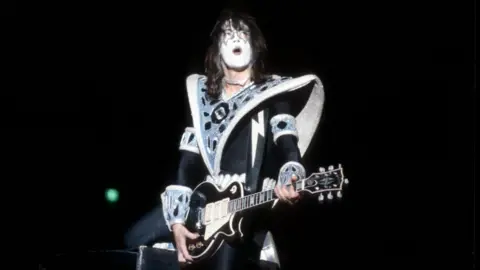 Getty Images Ace Frehley, in signature black and white KISS make-up, performs on guitar.