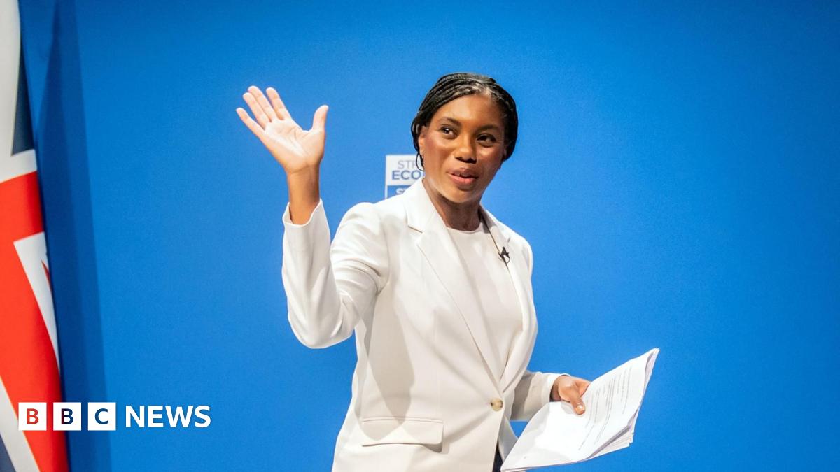 Jensen Huang, CEO of Nvidia, speaks during a news conference in Taipei in May. He is pictured holding a semiconductor unit while addressing the crowd.