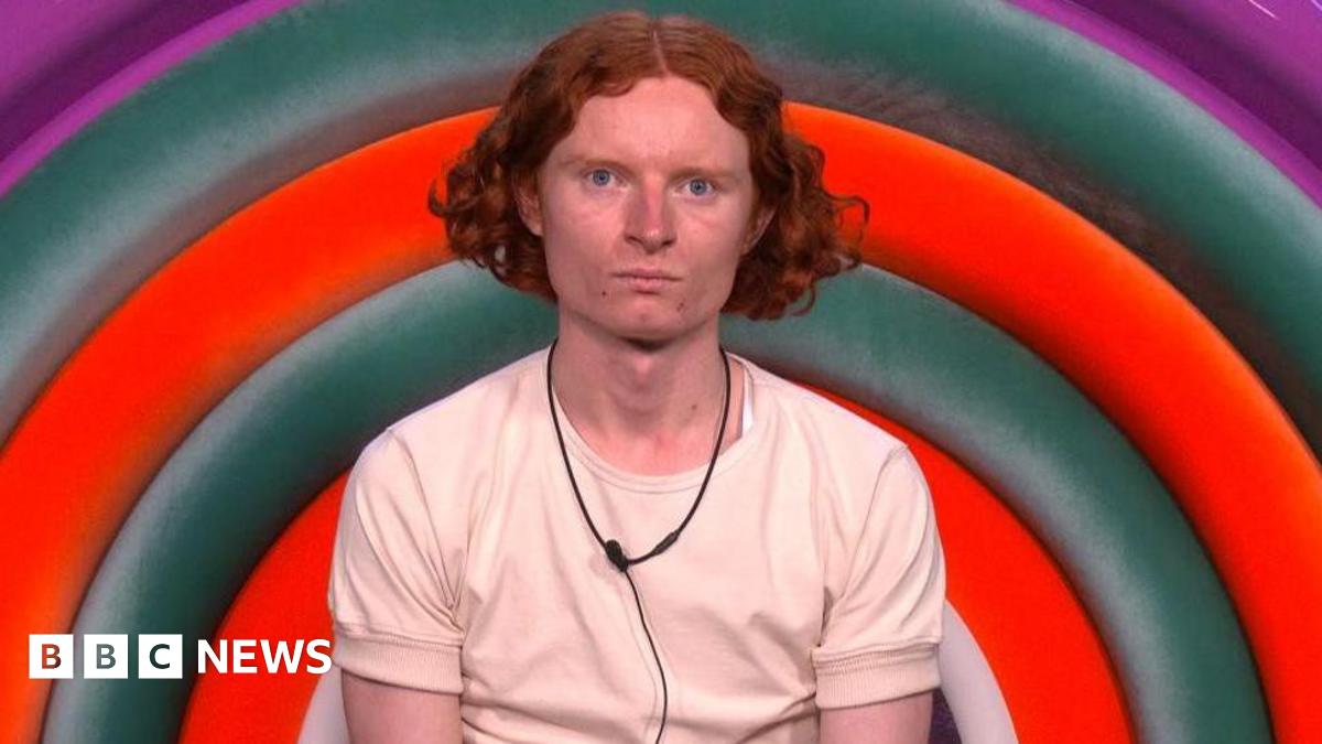 George Gilbert, wearing a cream T-shirt, looking at the camera in Big Brother's diary room