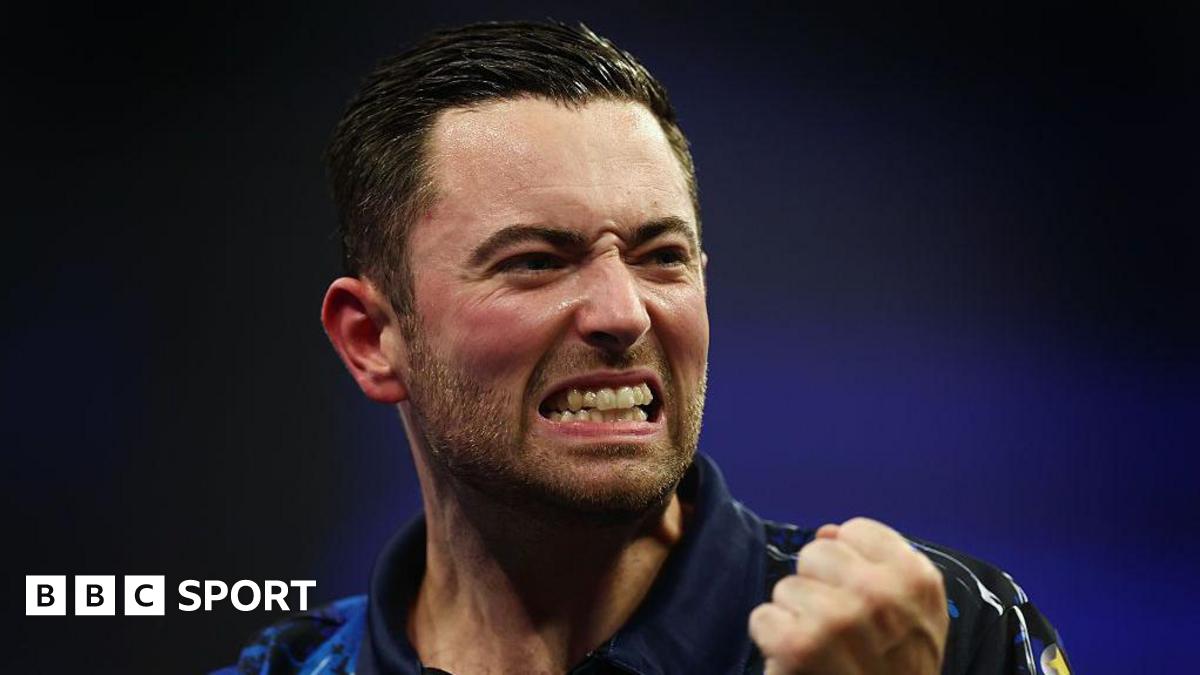 Luke Humphries clenches a fist in celebration