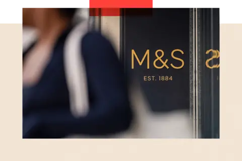 Bloomberg via Getty Images A sign outside the entrance to a Marks & Spencer Group Plc (M&S) store on Oxford Street in London