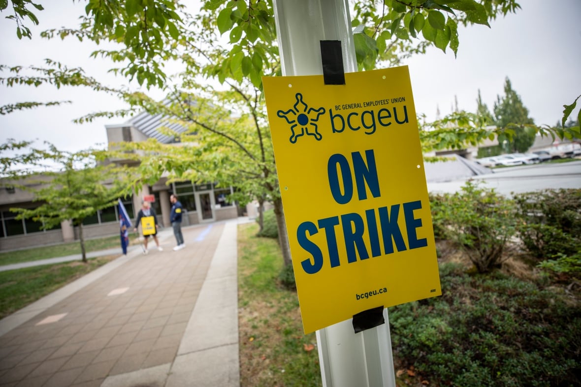 Members of the British Columbia General Employees' Union (BCGEU) picket outside the Surrey pretrial centre in Surrey, B.C., on Tuesday, Sept. 8, 2025.