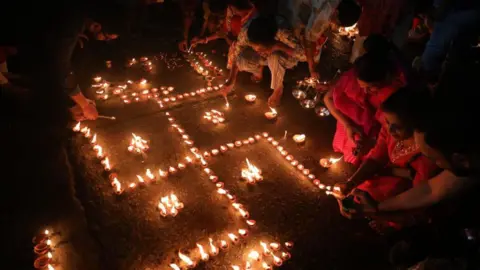 Getty Images Hindu devotees light oil lamps on the banks of the river Ganges on the occasion of the Hindu religious festival of Dev Deepawali in Kolkata, India, on November 15, 2024. 