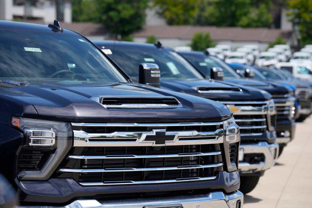 Unsold 2023 Silverado pickup trucks sit in a long row at a Chevrolet dealership Sunday, June 18, 2023, in Englewood, Colo. (AP Photo/David Zalubowski)