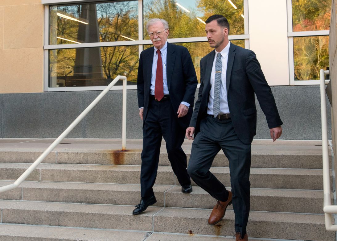Former Trump administration national security adviser John Bolton, left, departs following his arraignment at the federal courthouse in Greenbelt, Maryland, on Friday.