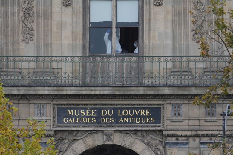 Police officers work inside the Louvre museum, Sunday, Oct. 19, 2025 in Paris.