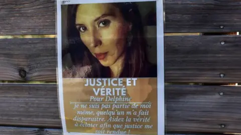 CHARLY TRIBALLEAU/AFP A photograph shows a poster, which reads as "Justice and truth for Delphine. I didn't leave by myself. Someone made me disappear"