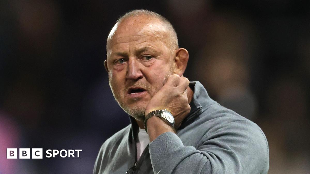 Steve Diamond scratching his cheek with his left hand on the sidelines during a Newcastle match