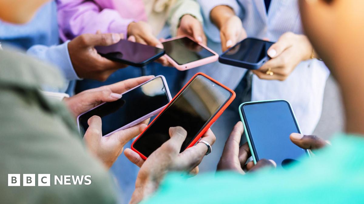 Jensen Huang, CEO of Nvidia, speaks during a news conference in Taipei in May. He is pictured holding a semiconductor unit while addressing the crowd.