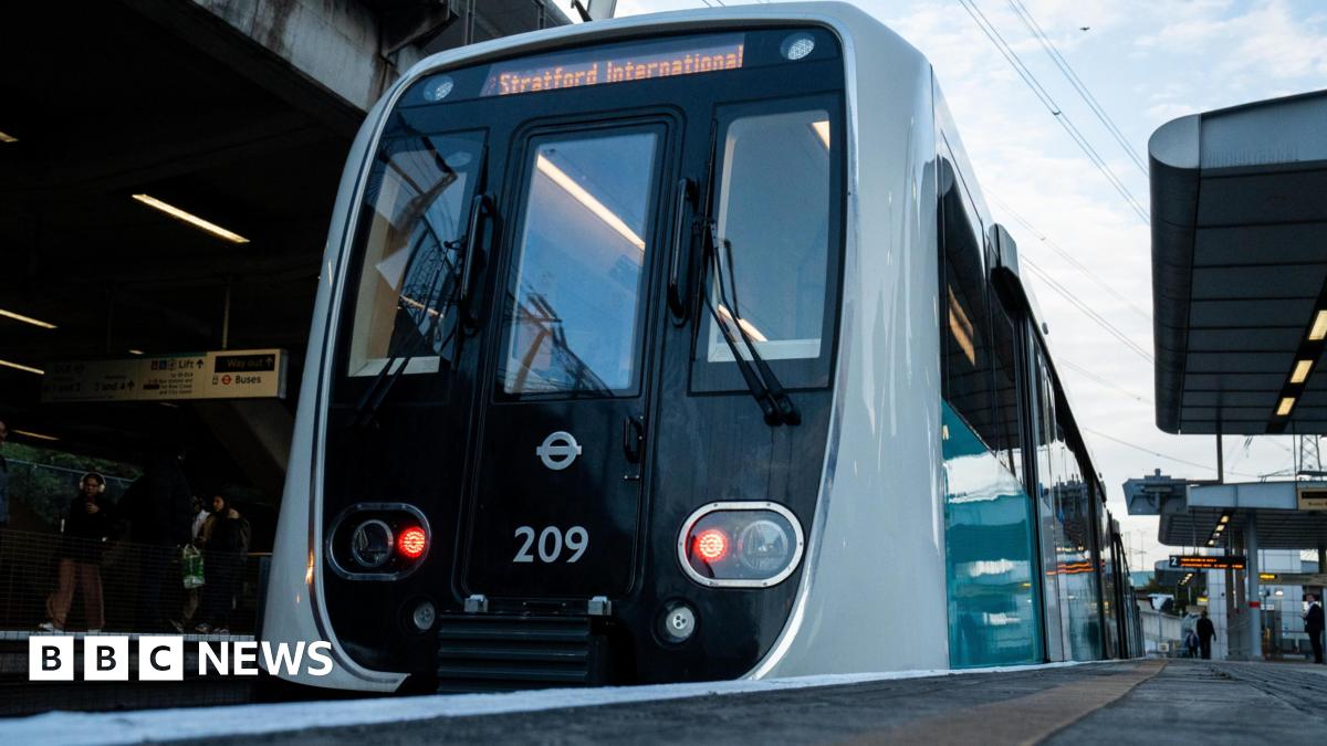 An image of a modern train at the platform in a DLR station.