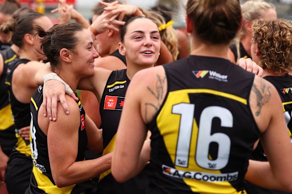 Richmond’s Monique Conti celebrates with Caitlin Greiser and Laura McClelland.