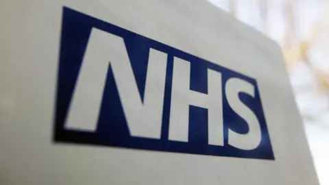 PA Media An image of the NHS logo 