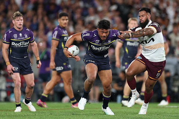 Stefano Utoikamanu is tackled by Payne Haas during the 2025 NRL grand final.