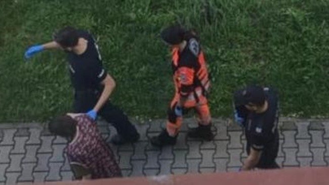 Police and paramedics walking with Mirella.